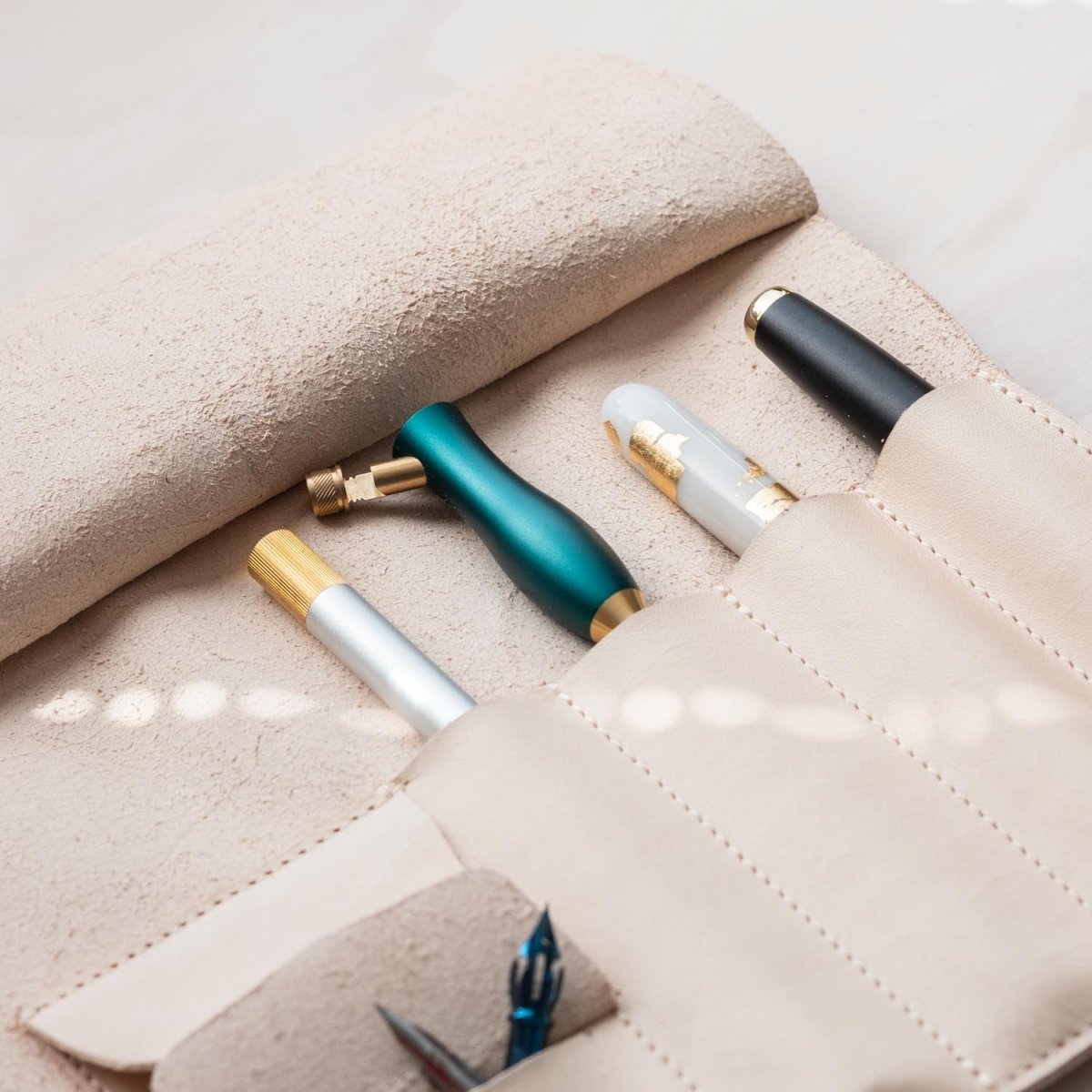 A close up of the pen holder section of the Leather Pen Roll, handmade by Edward de Lacy