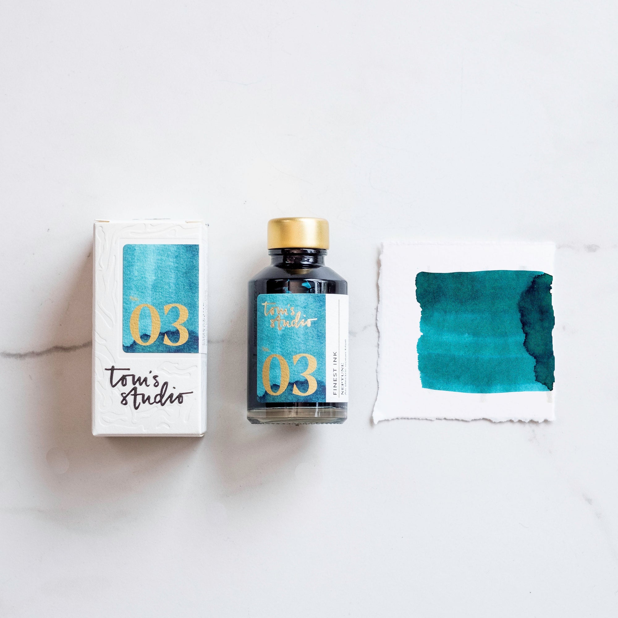 Tom's Studio Neptune Fountain Pen Ink – featuring the packaging, bottle and a swatch on paper