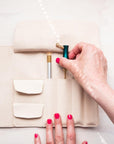 A calligrapher removing an oblique calligraphy pen from the handmade leather pen roll