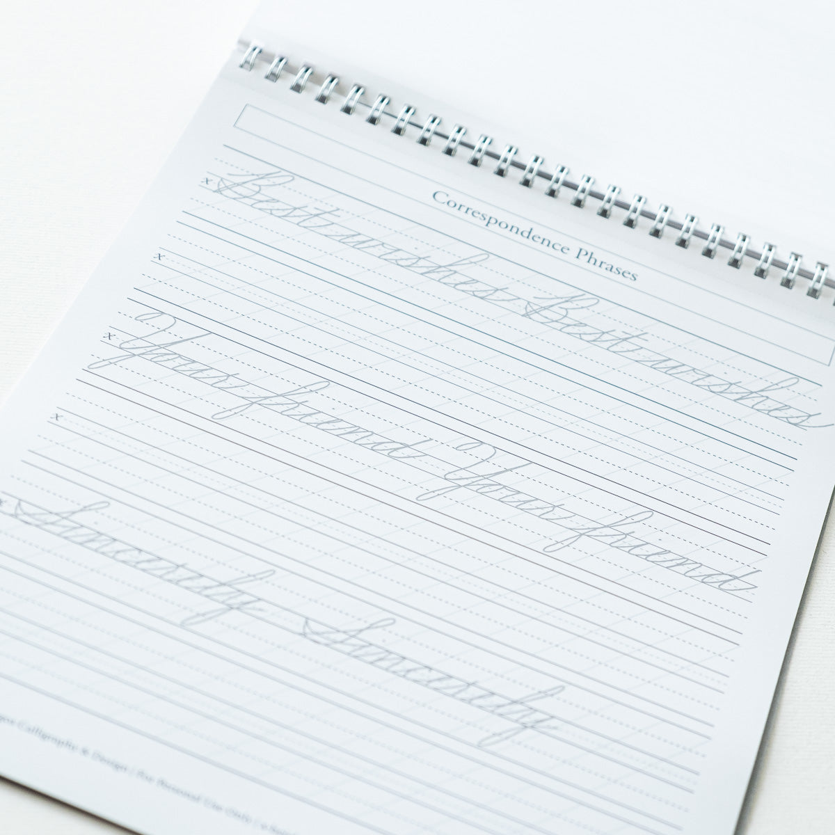 A sample page from Cursive Practice Workbook by Logos Calligraphy