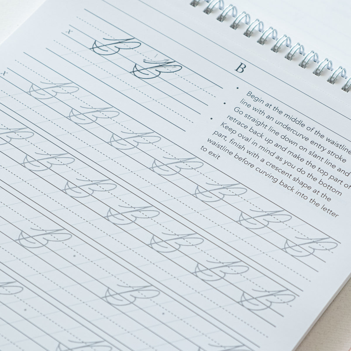 A sample page from Cursive Practice Workbook by Logos Calligraphy - Uppercase Letters