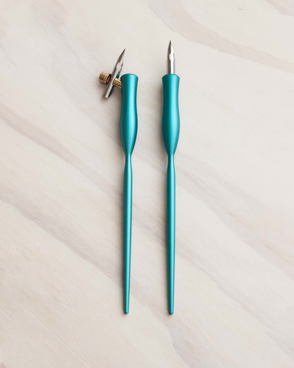 two calligraphy pens in bright teal finish one straight and one oblique