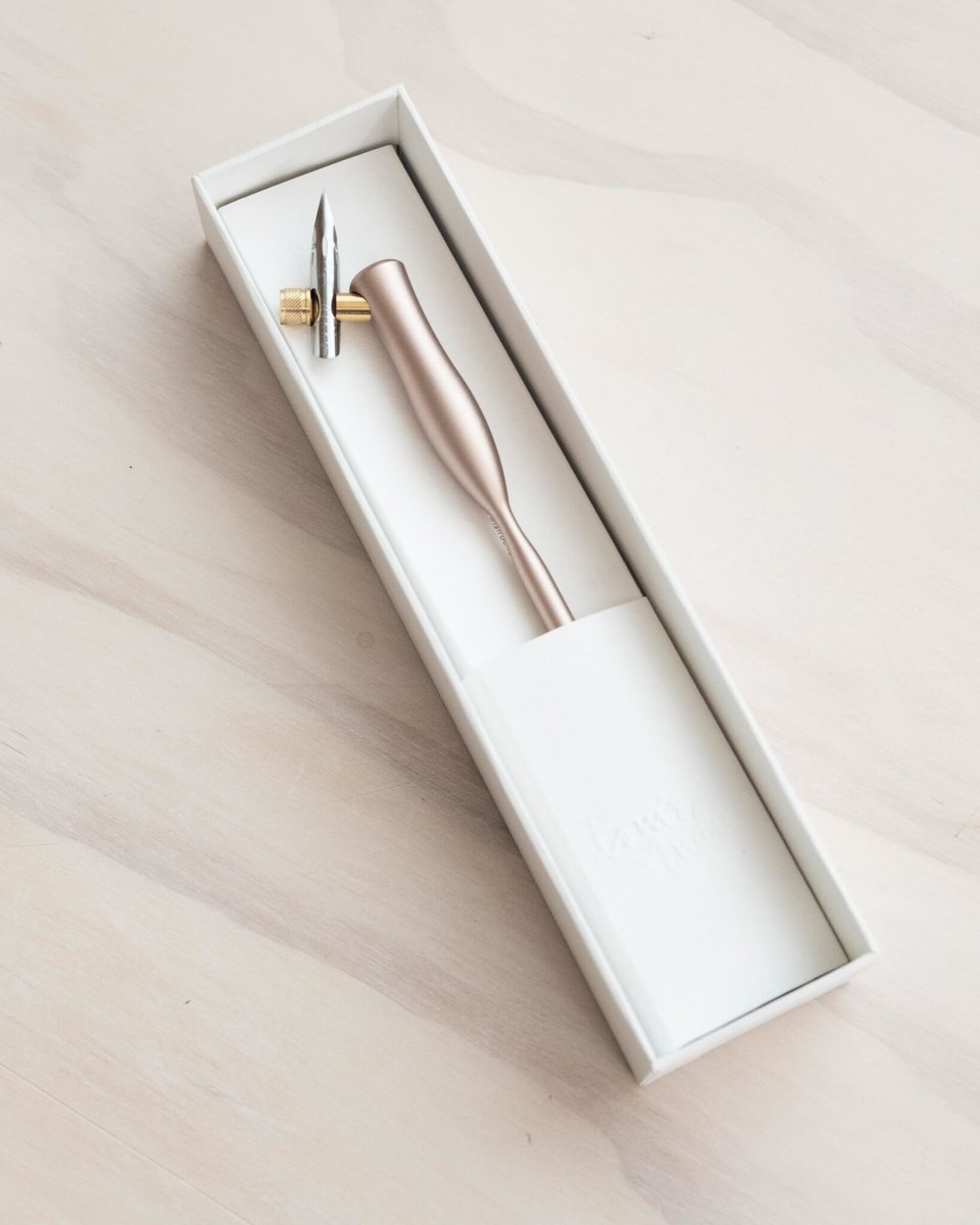 The silver oblique nib calligraphy pen shown in its box