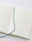 The MD Notebook Journal - open on a table with marker ribbon