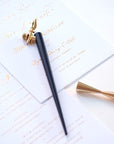 The Original Flourish Oblique Calligraphy Pen in Black with Butterfly Brass Pen Rest and sample of calligraphy