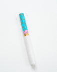 Pink + Turquoise Studio Fountain Pen closed on a white desk