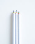 3 Rainbow pencils on a white desk