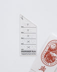 The Engrosser calligraphy ruler on paper with it's beautiful packaging
