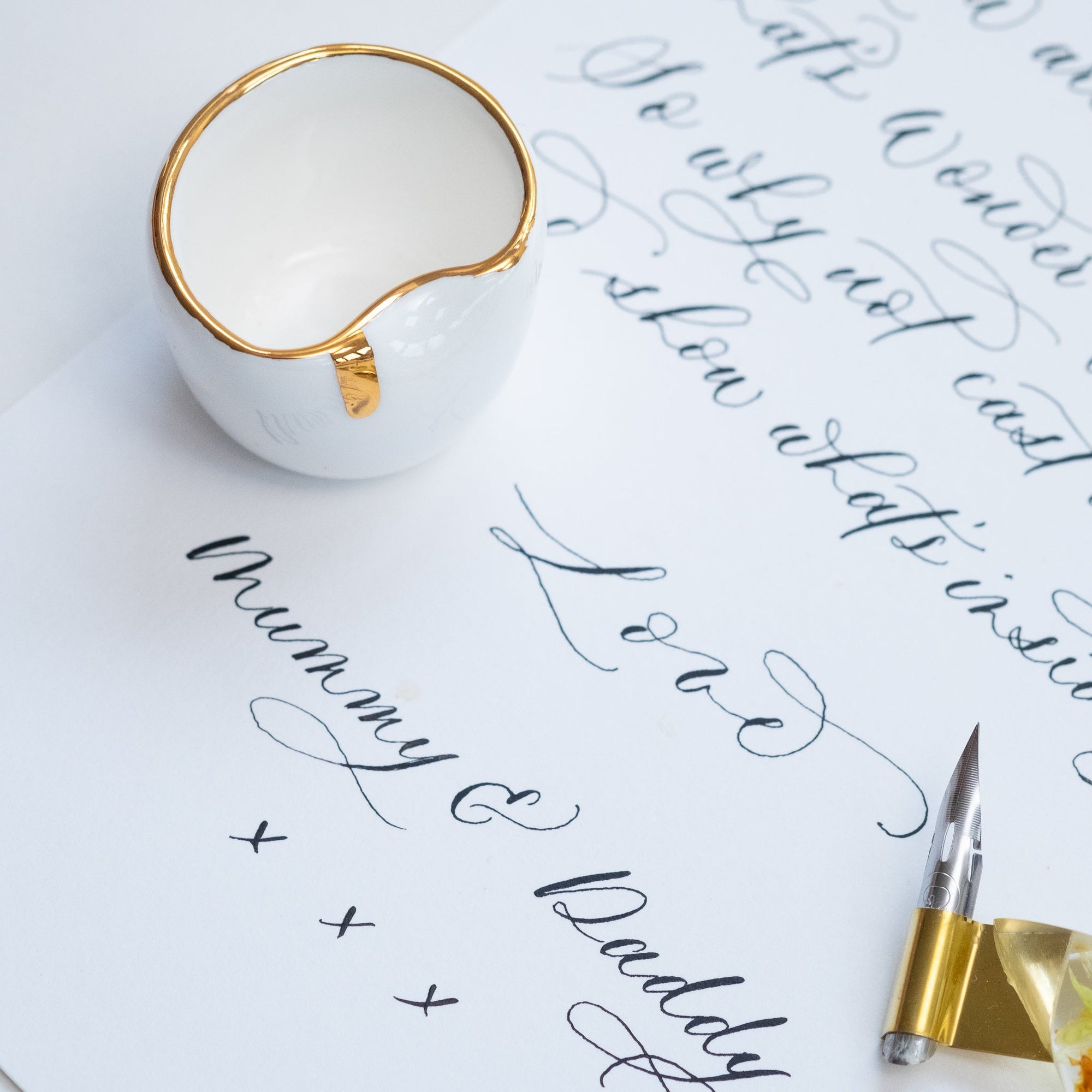 Fine Bone China Artist's Ink Well by Wendy Tournay on a sheet of paper with modern calligraphy written on it