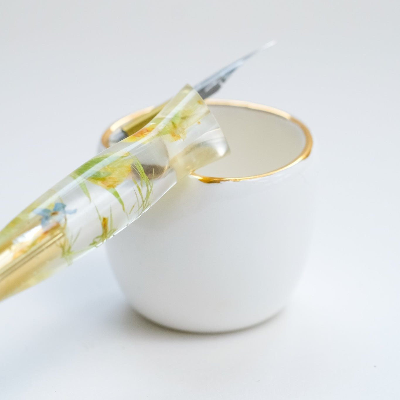 Fine Bone China Artist's Ink Well by Wendy Tournay with a calligraphy pen resting on it