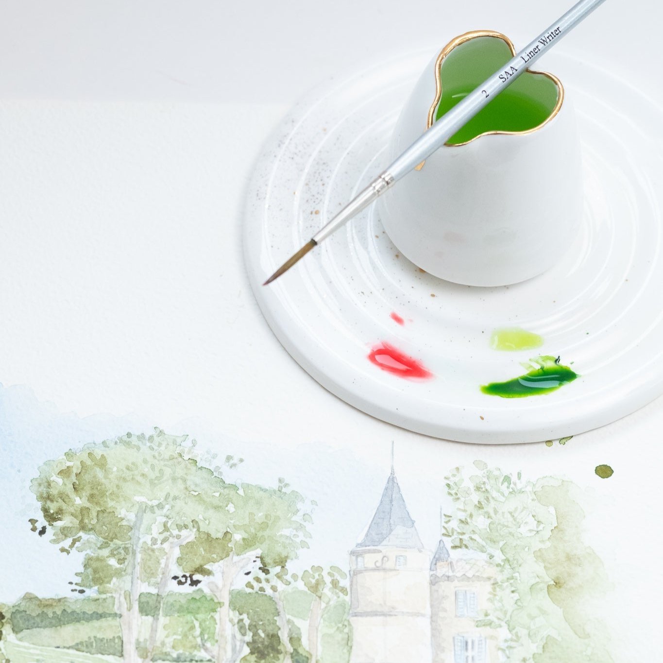 Fine Bone China Artist's Water Jug by Wendy Tournay with a paintbrush balanced on top and a palette with watercolour picture of a park