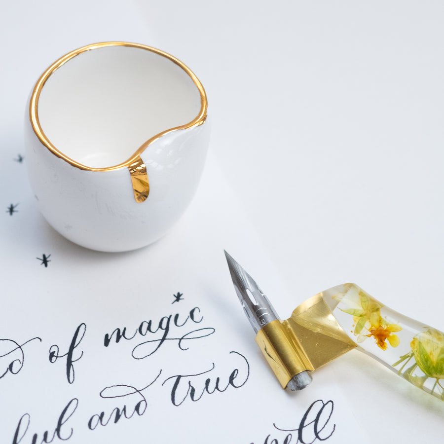 oblique calligraphy pen with a nikko g nib and a ceramic ink pot