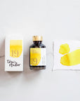 Lemon yellow fountain pen ink showing the bottle on a table alongside the box and a colour swatch