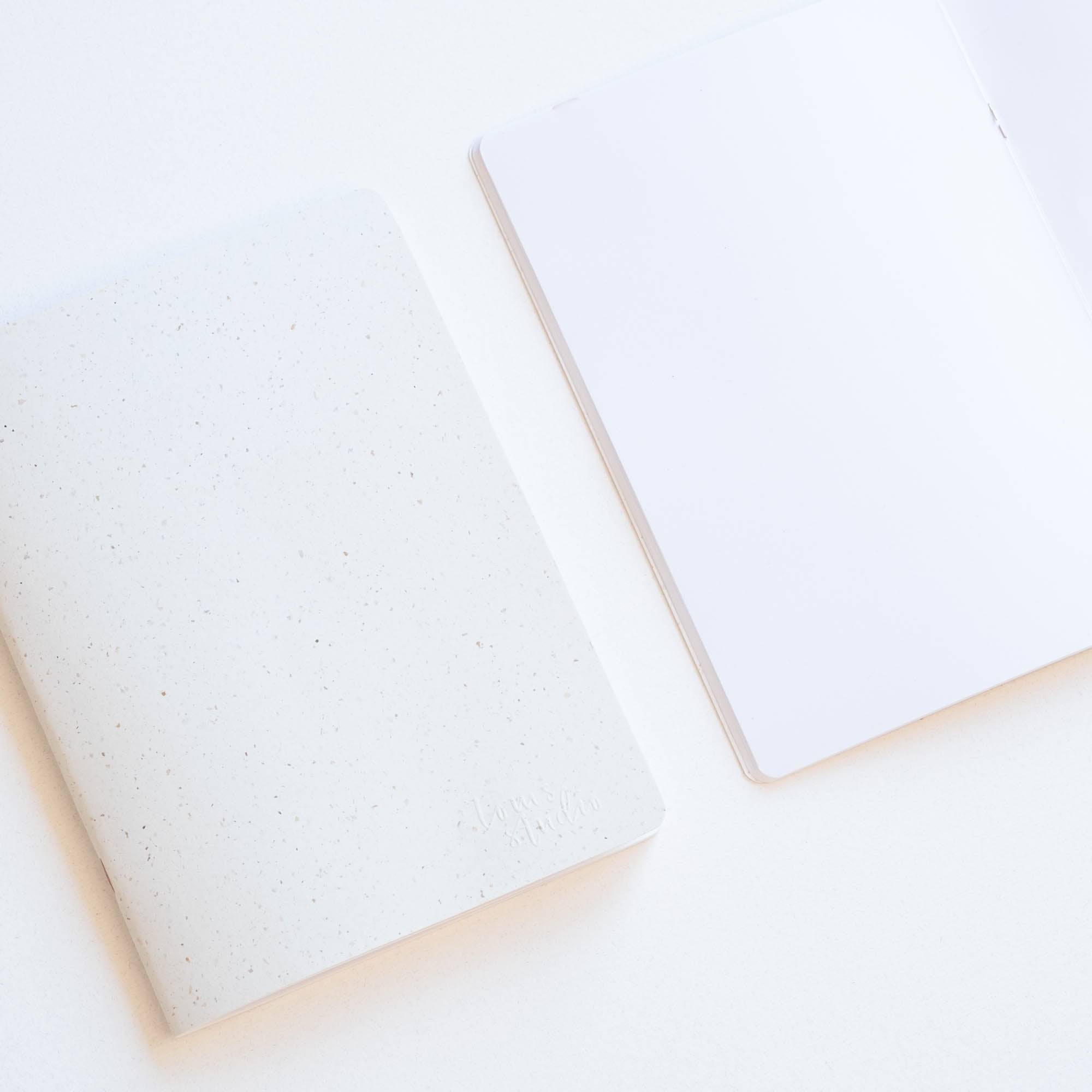 Tom's Studio x Coffeenotes A5 Notebook in 'Grounds' white, with plain pages, made from recycled coffee cups and eco-friendly materials.