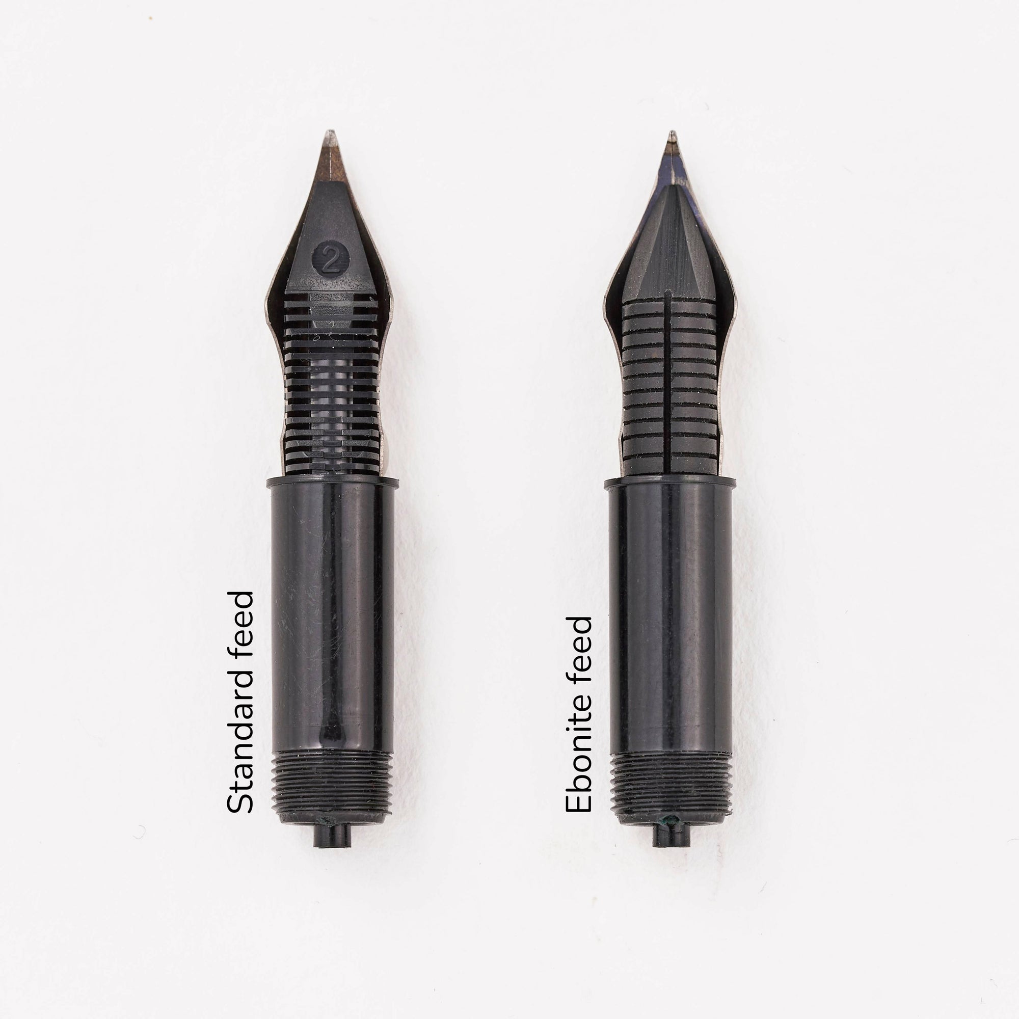 Side by side comparison of a standard injection moulded fountain pen feed and an ebonite feed