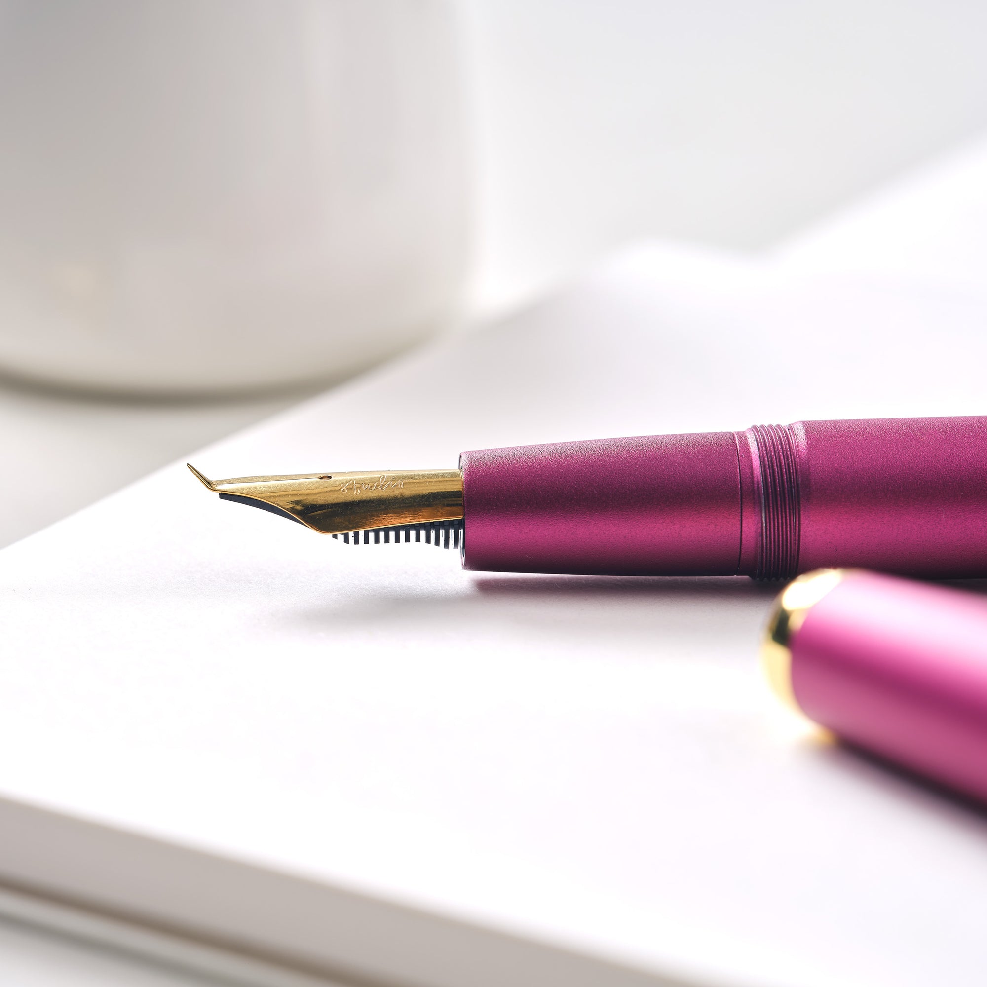 Fude fountain pen nib fitted in the Studio Fountain Pen, pictured resting on the Studio Pad