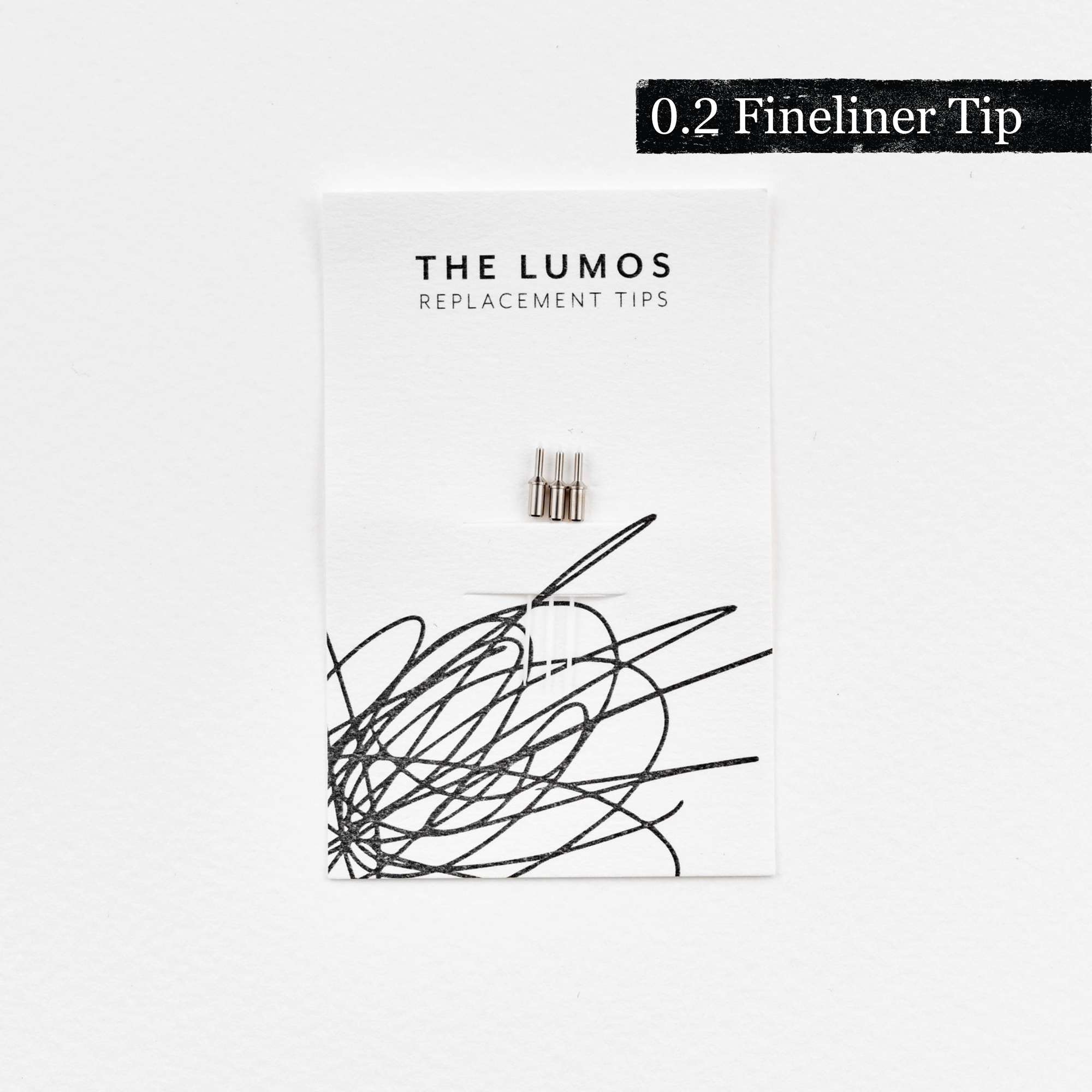 A pack of three Lumos 0.2mm fineliner replacement tips attached to a white backing card. The card features 'THE LUMOS REPLACEMENT TIPS' in uppercase black letters at the top, with an abstract black ink scribble design in the lower half. A black textured label in the upper right corner displays '0.2 Fineliner Tip' in white text. 