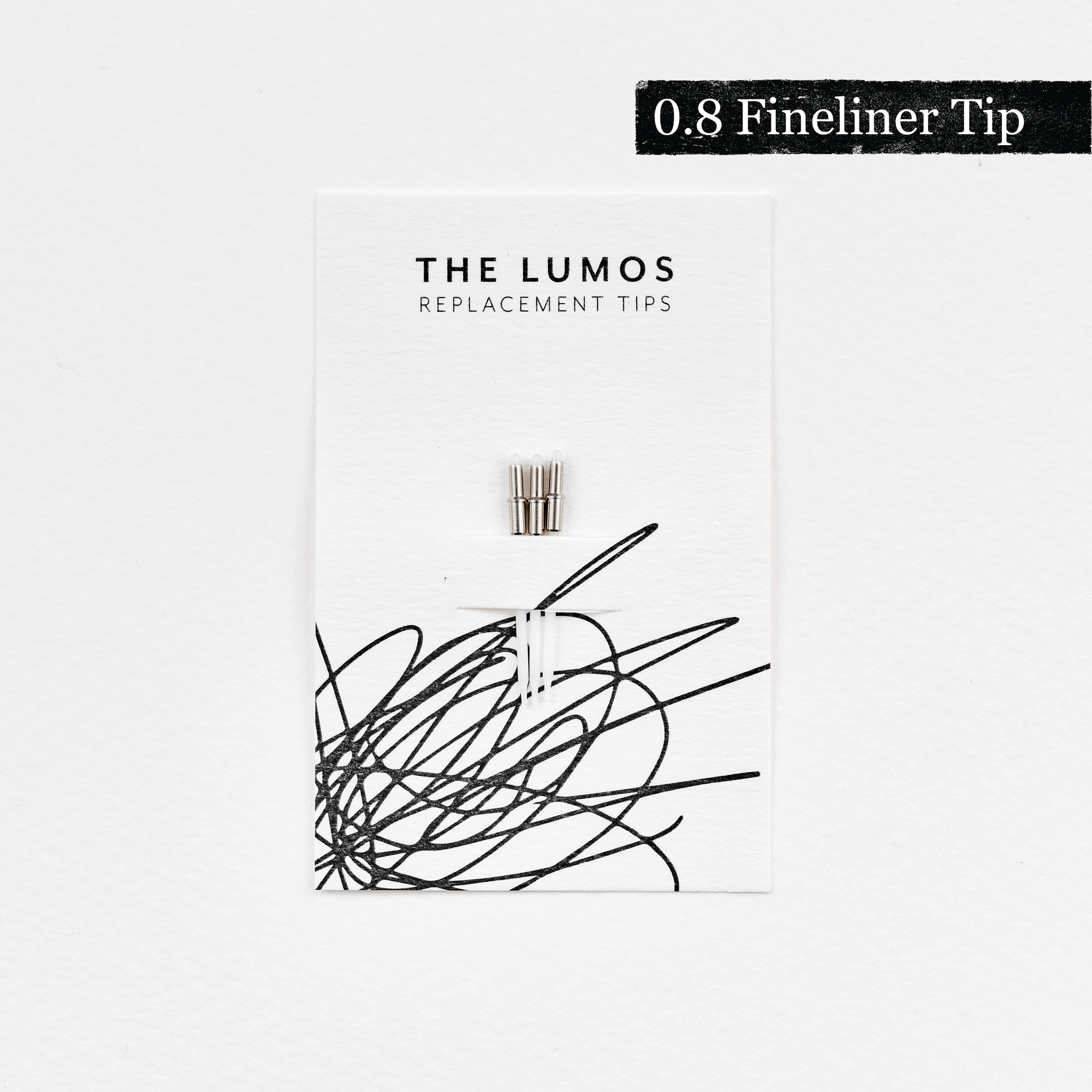 A pack of three Lumos 0.8mm fineliner replacement tips attached to a white backing card. The card features &#39;THE LUMOS REPLACEMENT TIPS&#39; in uppercase black letters at the top, with an abstract black ink scribble design in the lower half. A black textured label in the upper right corner displays &#39;0.8 Fineliner Tip&#39; in white text. 