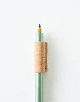 Handmade by Edward De Lacy, a pen grip and rollstop for the Lumos refillable pen – shown in cork on the sage Lumos