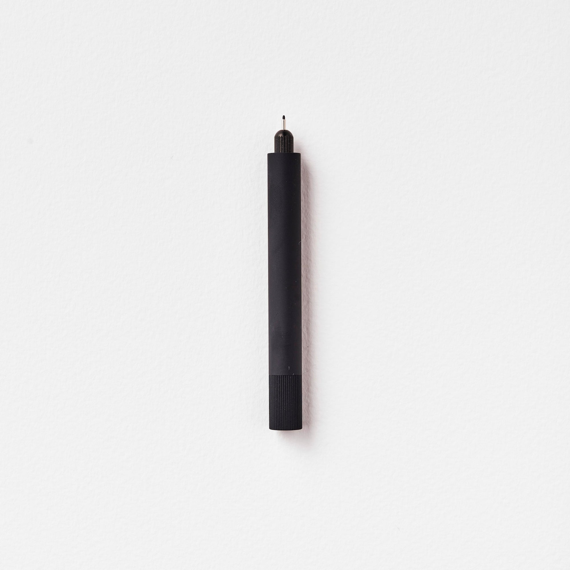 The Lumos Mini Refillable Pen in Matte Black on white background