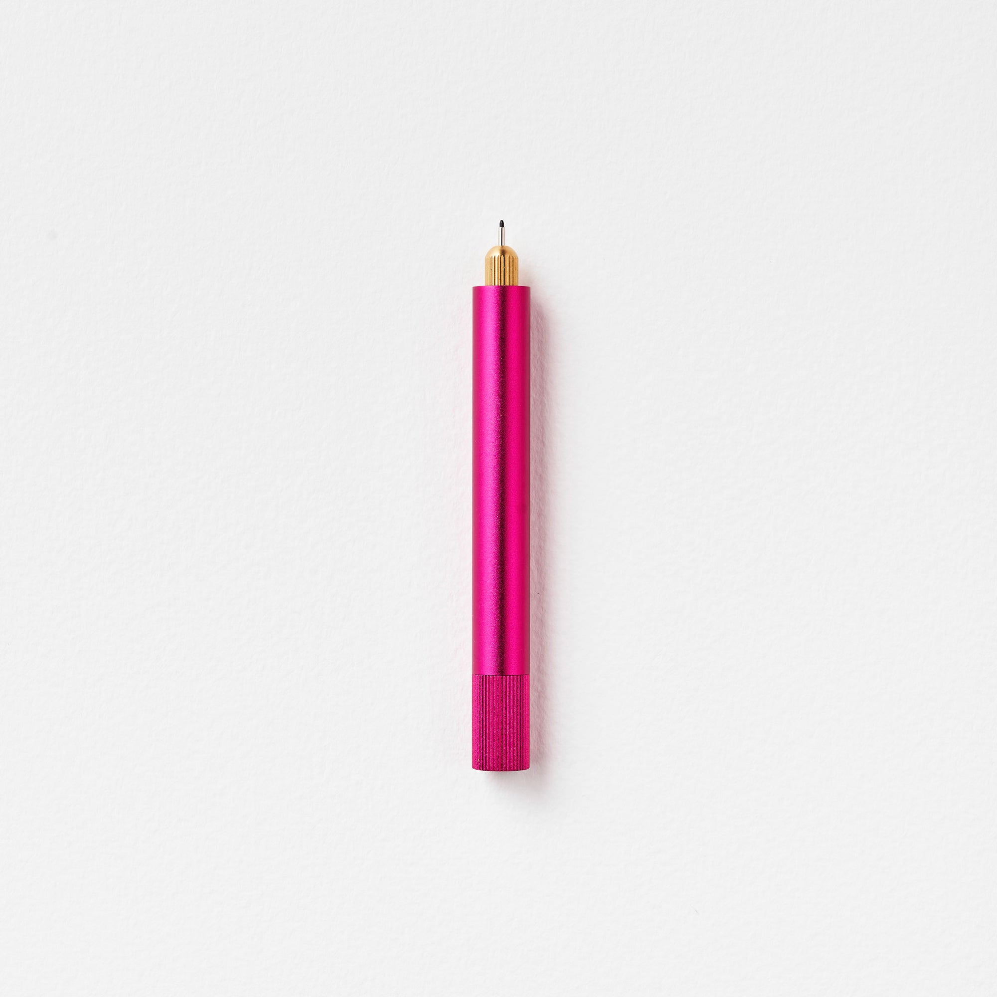 The Lumos Mini Refillable Pen in Raspberry on white background