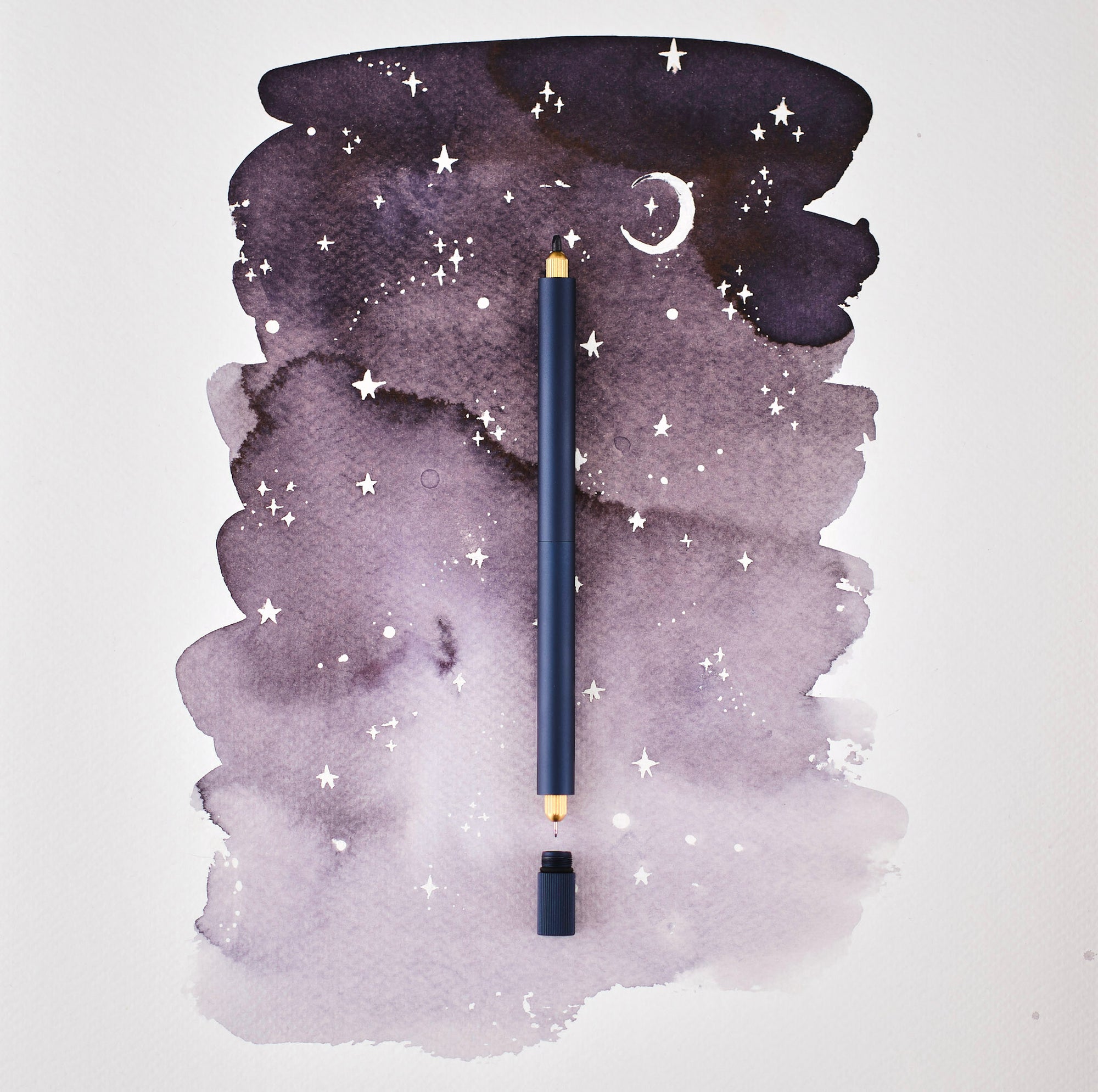 The Lumos Pro Duo Refillable Pen in Midnight on illustrative background