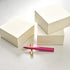 Three MD Memo Blocks – plain, ruled and grid, with the Wren refillable writing pen in Raspberry on a Brass Butterfly Pen Rest.