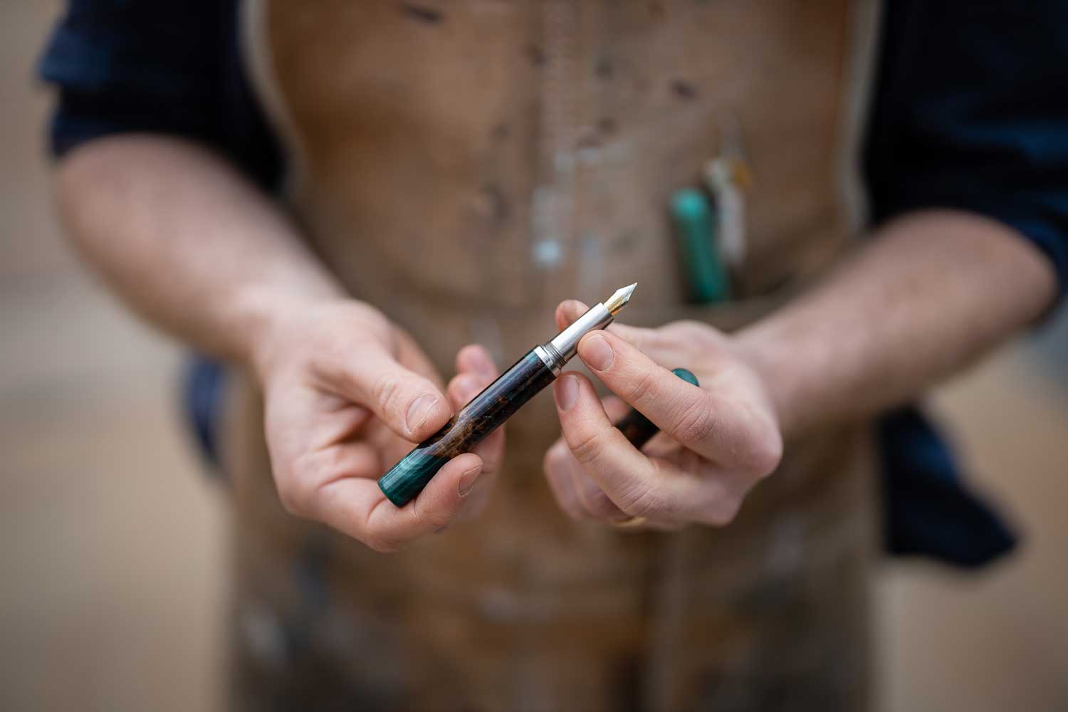 Tom holding a handmade wood and resin fountain pen