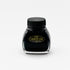 A front-facing image of the Platinum Carbon Ink bottle. The label is fully visible, featuring the "Carbon Ink" logo in gold lettering against a black background. The glass bottle has a distinctive shape, and the deep black ink inside is prominently displayed.