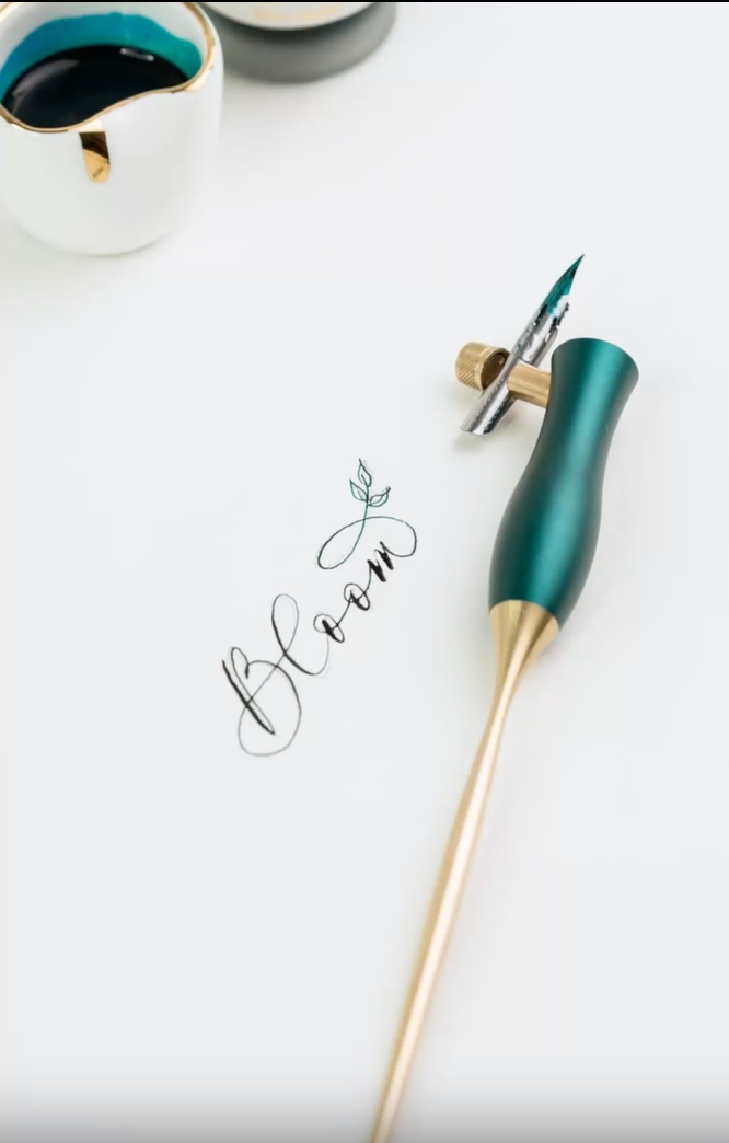 The Bloom calligraphy pen with blique nib setting in Ivy, in use