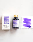 Tom's Studio Amethyst Shimmer Fountain Pen Ink with two pens with inky goodness on paper with an ink swatch demonstrating the colour