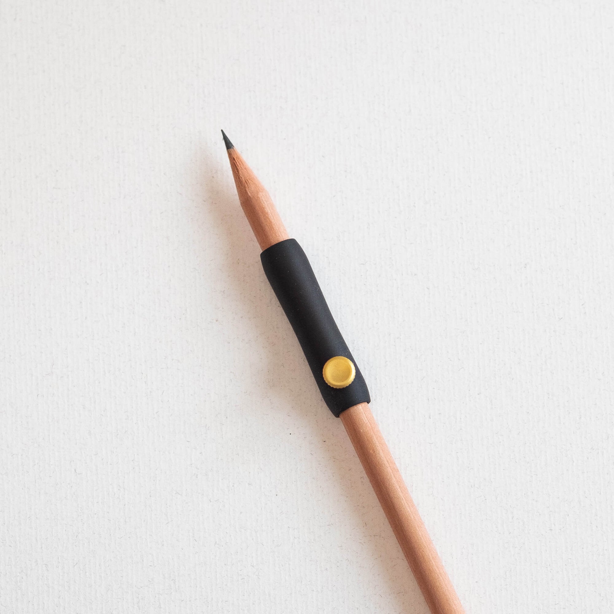 The Poise Pencil Grip Extender in Black shown on a standard pencil.