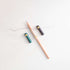 The Poise Pencil Grip Extender in (left to right) Ivy, Blush and Black. Shown on a standard pencil.
