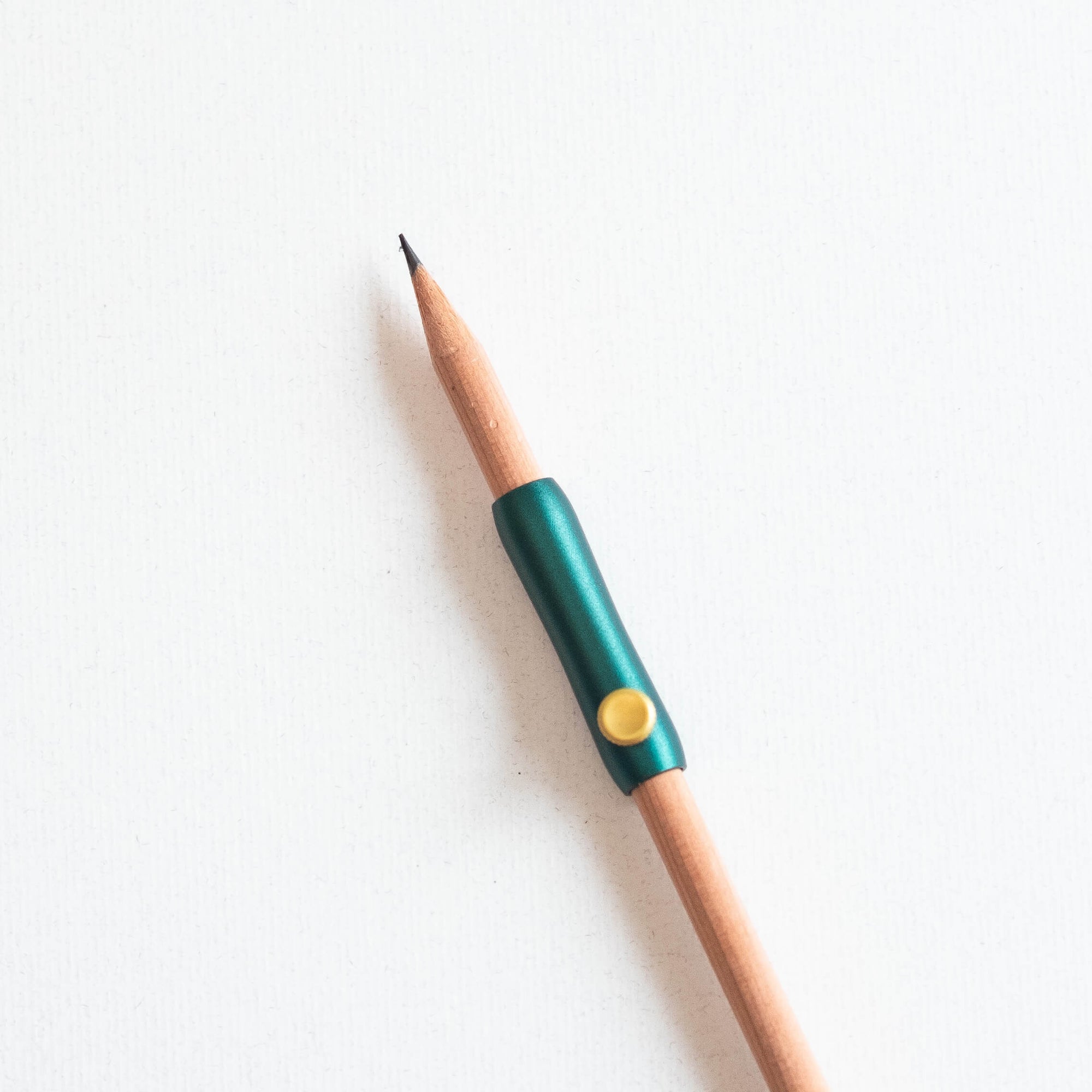 The Poise Pencil Grip Extender in Ivy shown on a standard pencil.