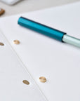 Detail shot of solid brass studs in use in the open Studio Pad refillable, customisable notebook and organiser