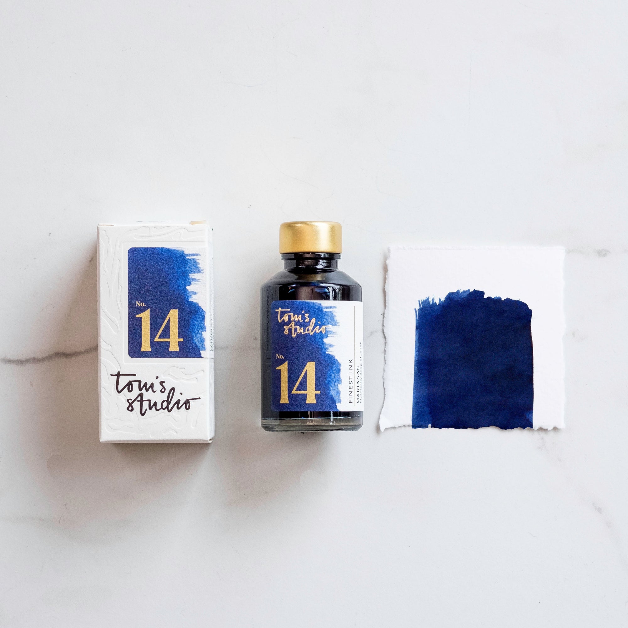 Tom's Studio Marianas Fountain Pen Ink with two pens with inky goodness on paper with an ink swatch demonstrating the colour