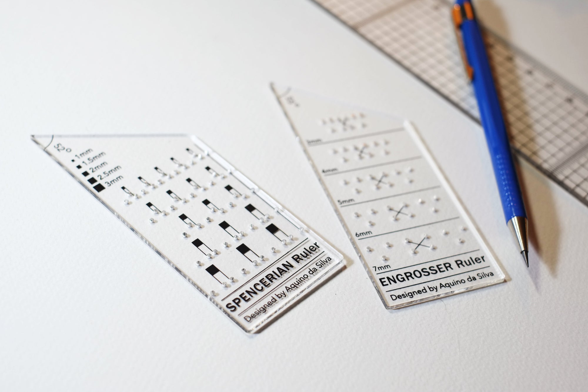 The Engrosser and Spencerian calligraphy ruler by Aquino da Silva shown with mechanical pencil