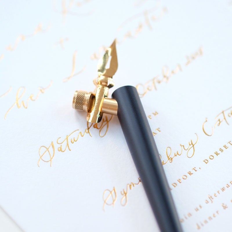 The Original Flourish Straight Calligraphy Pen in Black shown on a sample of calligraphy