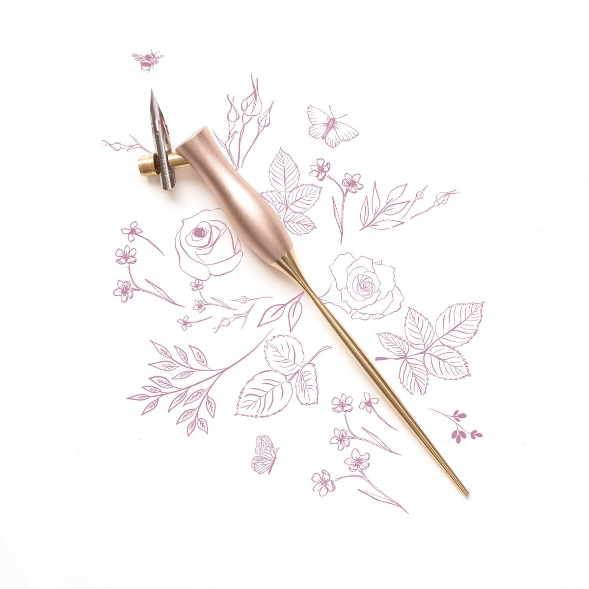 The bloom calligraphy pen with offset nib installed on a decorative background