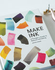 Make Ink by Jason Logan book cover shown with the Carrot Calligraphy Pen and Butterfly Brass Pen Rest