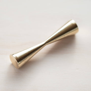 The butterfly brass pen rest for calligraphy pens on a wooden table