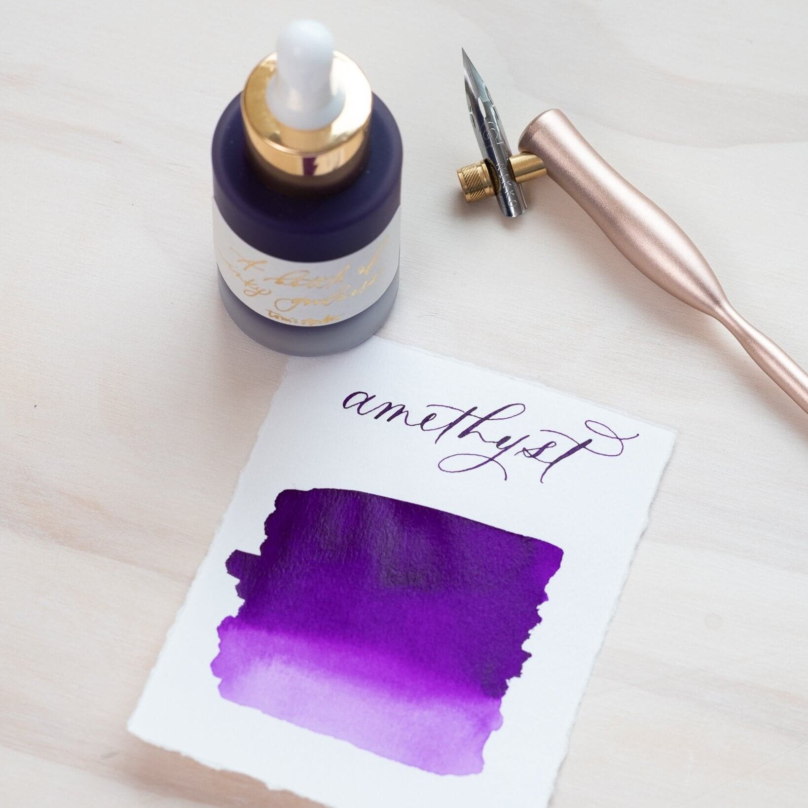 Amethyst - Calligraphy Ink in bottle with swatch showing the ink colour