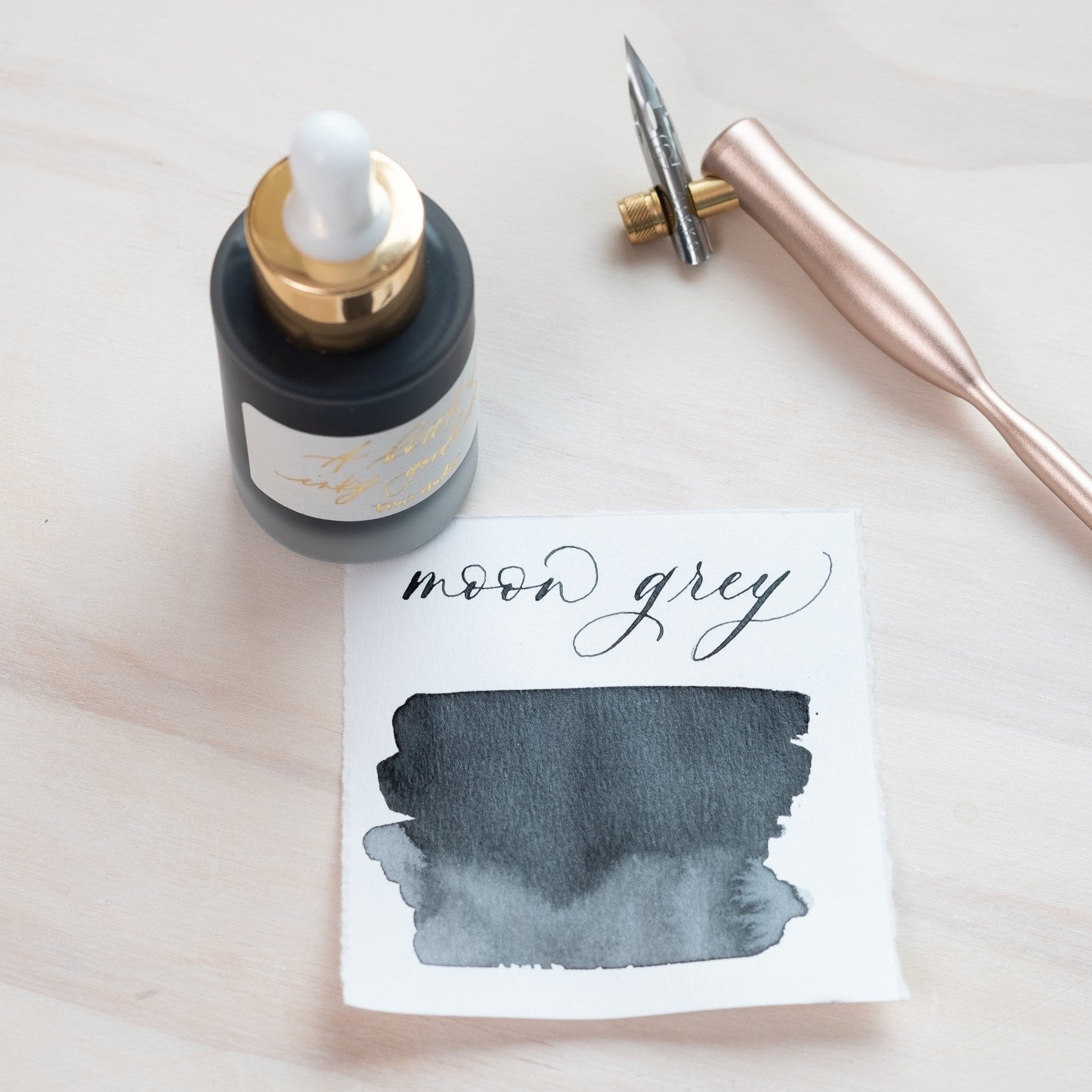 Moon Grey - Calligraphy Ink in bottle with swatch showing the ink colour