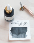 Moon Grey - Calligraphy Ink in bottle with swatch showing the ink colour