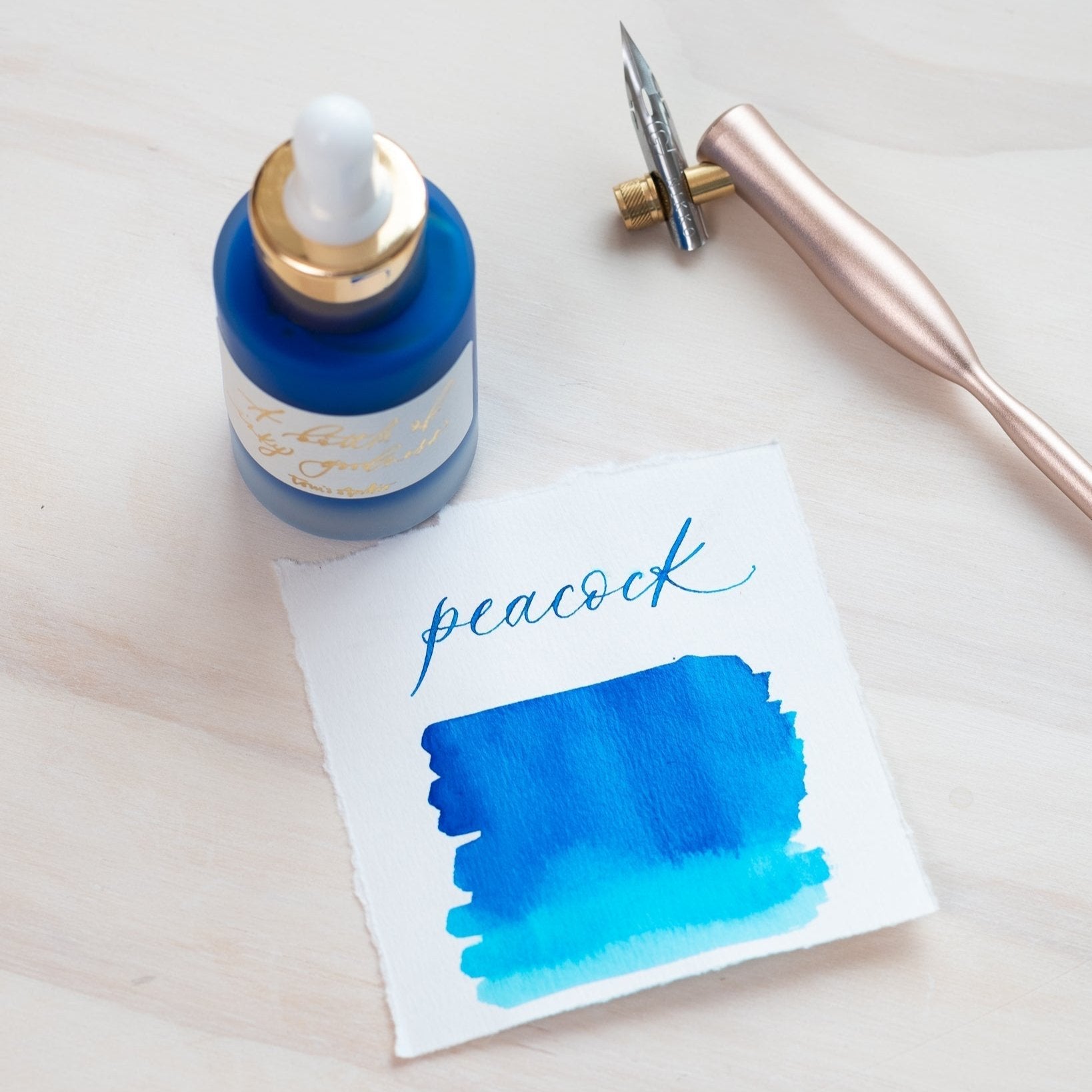 Peacock - Calligraphy Ink in bottle with swatch showing the ink colour