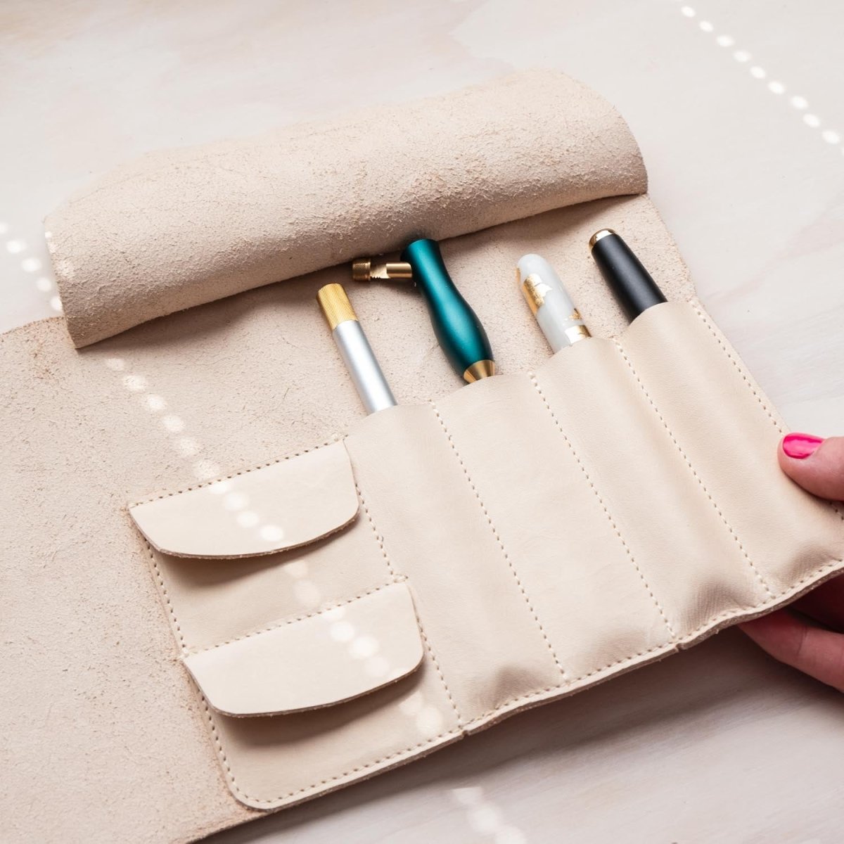 pens stored in the handmade leather pen roll