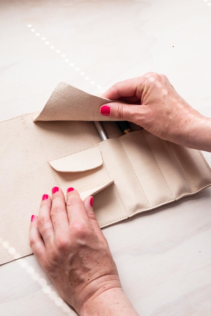 Removing a refillable fineliner from the handmade leather pen roll