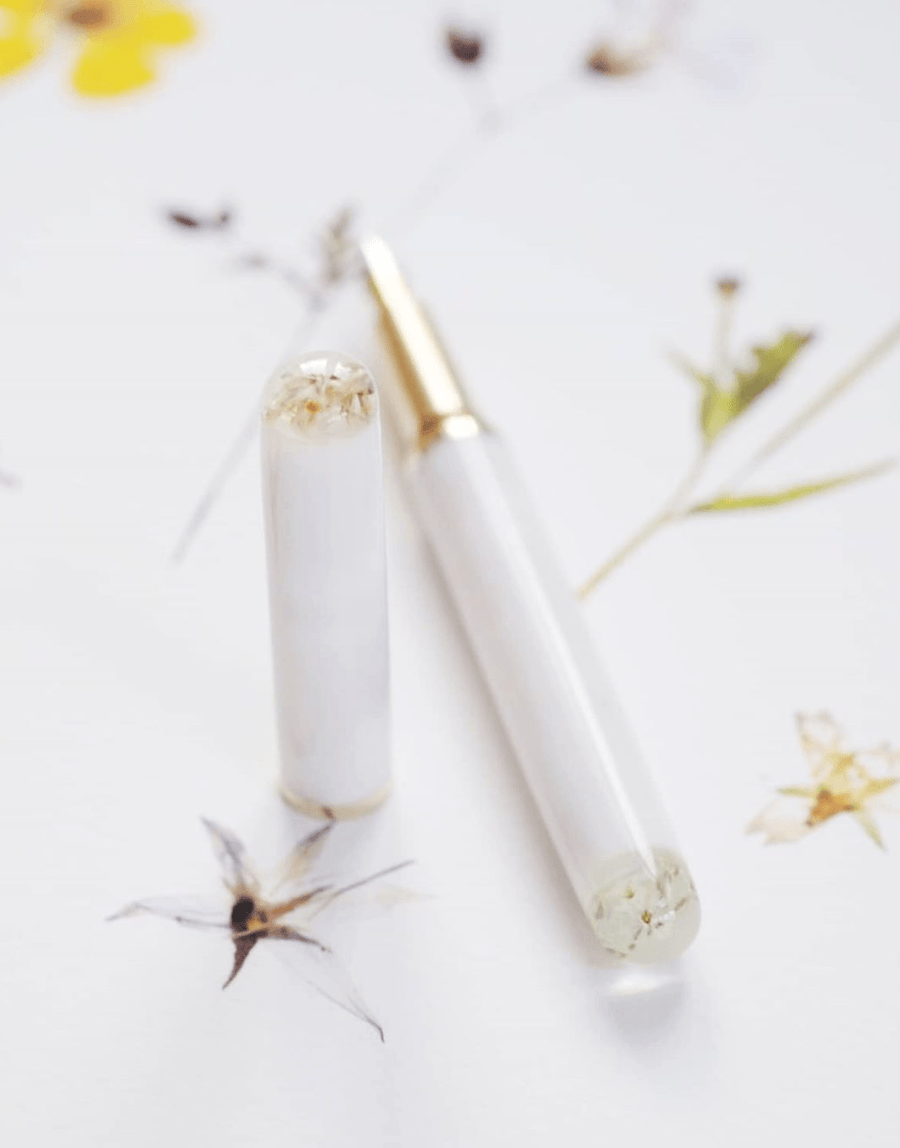 Encapsulated Flower Marble Studio fountain Pen on a white desk