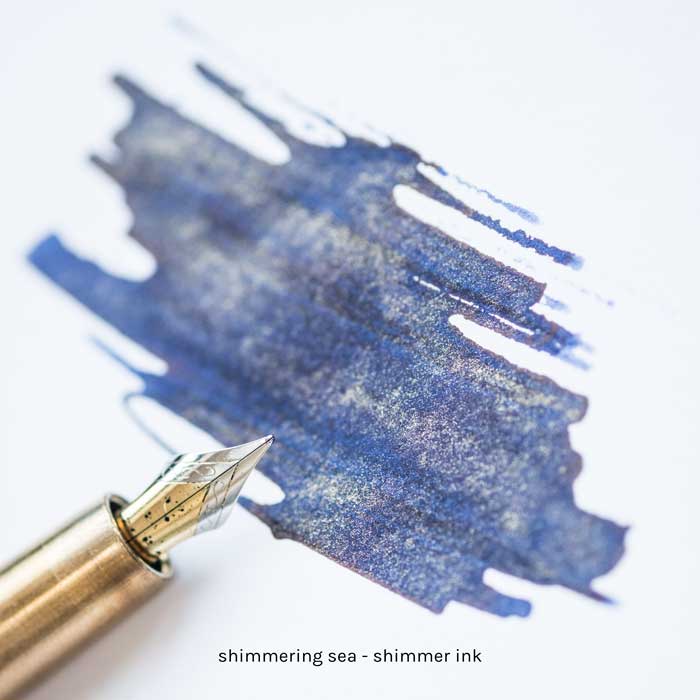 Enchanted Ocean Shimmer Fountain Pen Ink swatch with a fountain pen