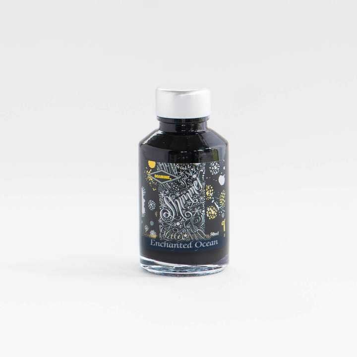 Enchanted Ocean Shimmer Fountain Pen Ink in bottle on a white desk